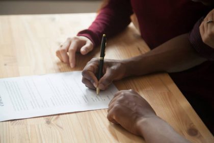 African,American,Man,Signing,Contract,,Black,Man,Hand,Putting,Signature HOA lawyer